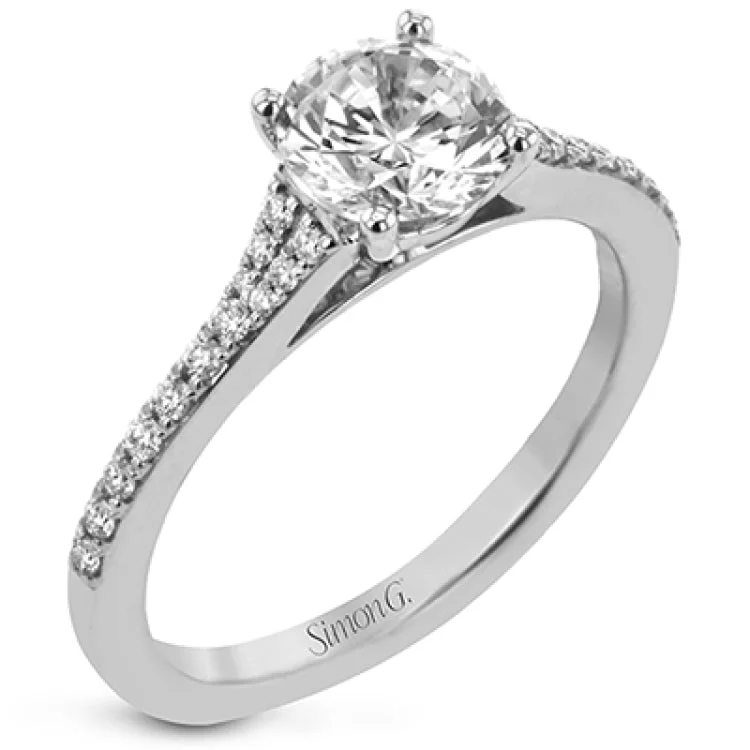 Women’s pear-shaped engagement rings-Simple yet stunning, this graceful engagement ring is made for a round cut center stone and is set with .16 ctw of white diamonds.