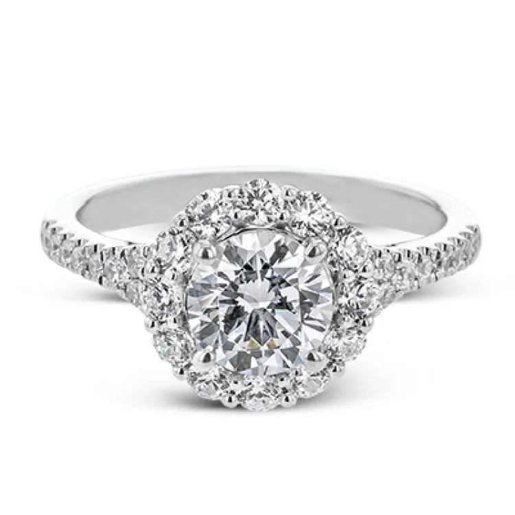 Women’s multi-stone engagement rings-This lovely engagement ring provides an impressive amount of sparkle with .73 ctw in a halo design.