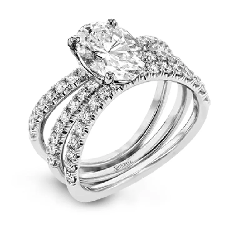 Women’s contemporary engagement rings-This distinctive bridal set design features a double-layer wedding band that fits around the engagement ring. The set contains .77 ctw of white diamonds.