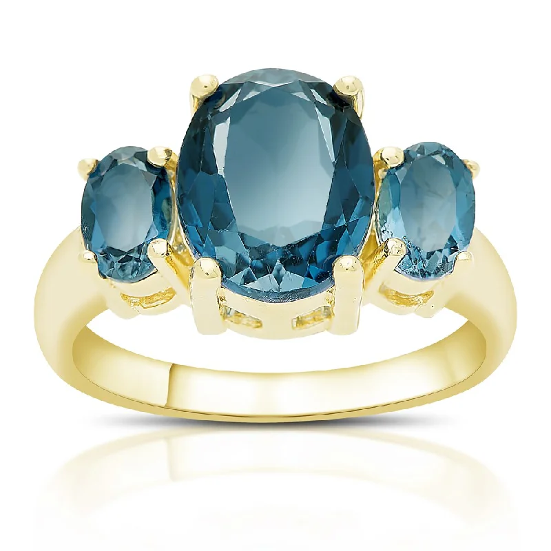 Women’s ruby rings-Dolce Giavonna Gold Over Sterling Silver London Blue Topaz Three Stone Ring