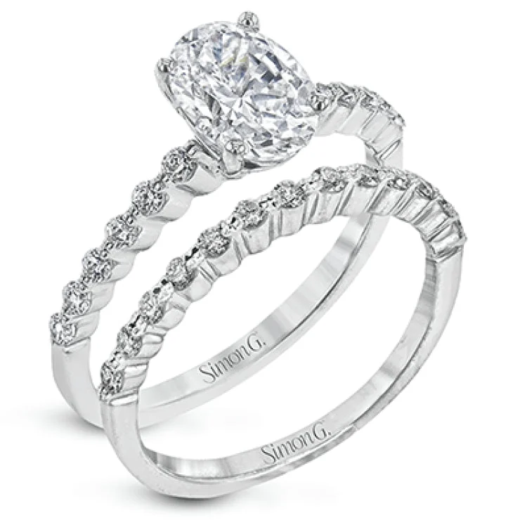 Women’s cushion cut engagement rings-This contemporary wedding set features .48 ctw of diamond side stones and is designed to perfectly showcase an oval center stone.