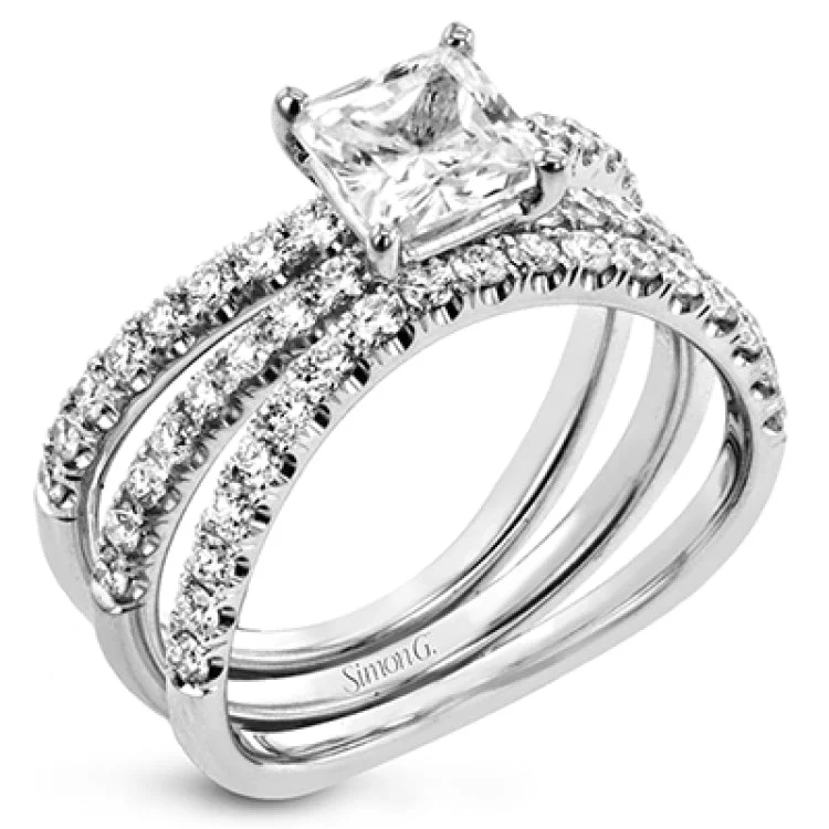 Women’s marquise engagement rings-This distinctive bridal set design features a double-layer wedding band that fits around the engagement ring. The set contains .77 ctw of white diamonds.