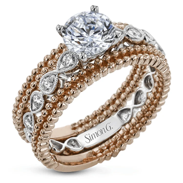 Women’s antique-style engagement rings-This wedding set features a white gold vintage inspired engagement ring in the center with a yellow gold granulated ring guard that provides a unique look.