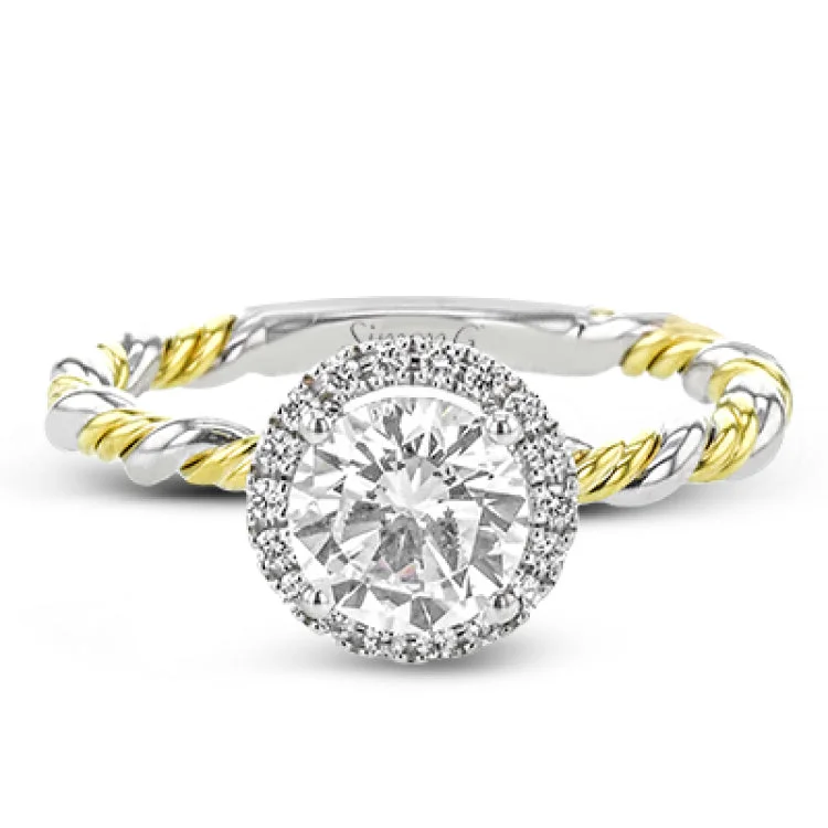 Women’s engagement rings with baguette diamonds-This ring is a twist on a halo engagement ring, with 18k yellow and white gold intertwining in the band.